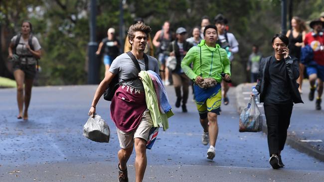 Spectators run to get a vantage point at Mrs Macquarie's Chair in Sydney.