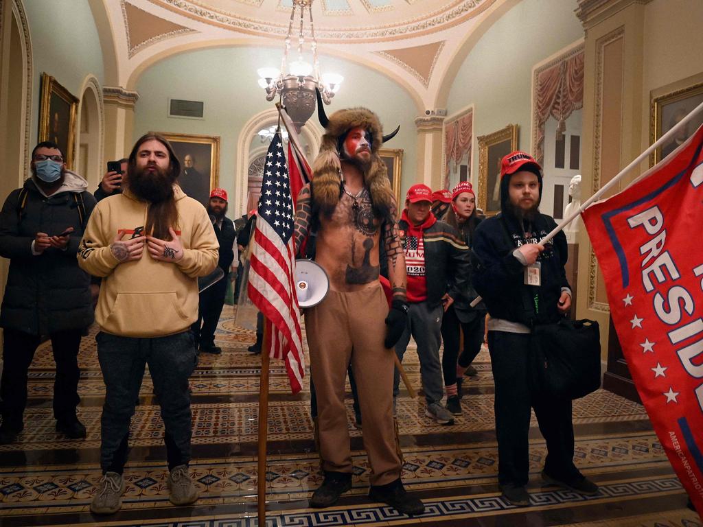 Supporters of US President Donald Trump, including member of the QAnon conspiracy group Jake Angeli, aka Yellowstone Wolf, entered the US Capitol on January 6, 2021. Picture: AFP