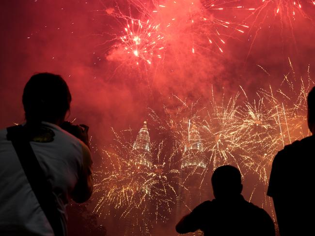 Spectators watch as fireworks explode in front of Malaysia's landmark building, the Petronas Twin Towers. Picture: AP