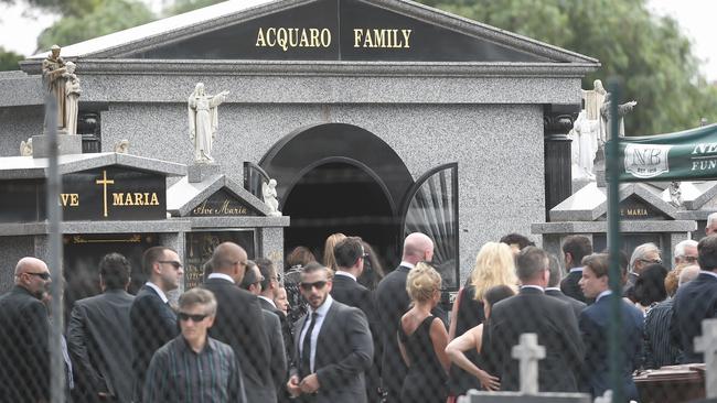 Mourners at the Acquaro family tomb in Footscray during the funeral for Joe Acquaro. Picture: Jake Nowakowski