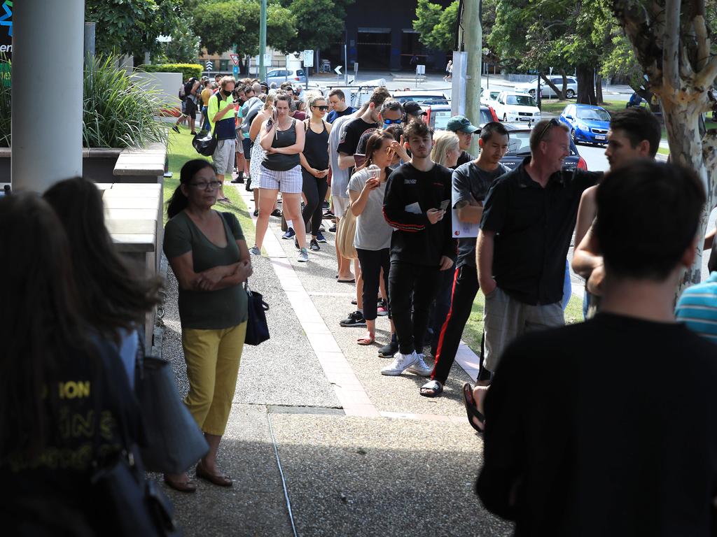 Lines of people wait at Southport Centrelink. Picture: Adam Head.