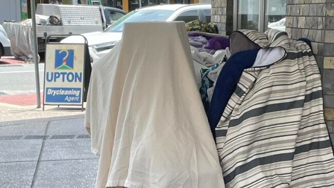 A homeless camp in the Southport CBD. An elderly lady has been using shopping trolleys to protect her area.