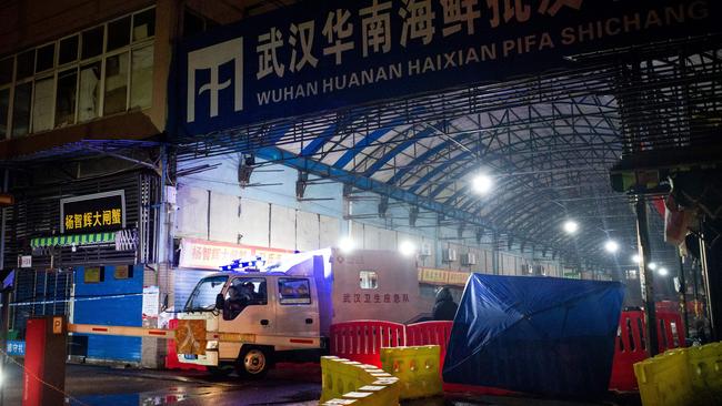 Members of staff of the Wuhan Hygiene Emergency Response Team drive their vehicle as they leave the closed Huanan Seafood Wholesale Market in the city of Wuhan. Picture: AFP