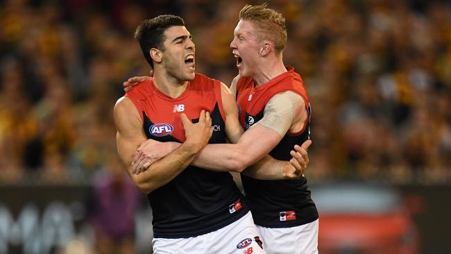 Christian Petracca and Clayton Oliver celebrate a goal.