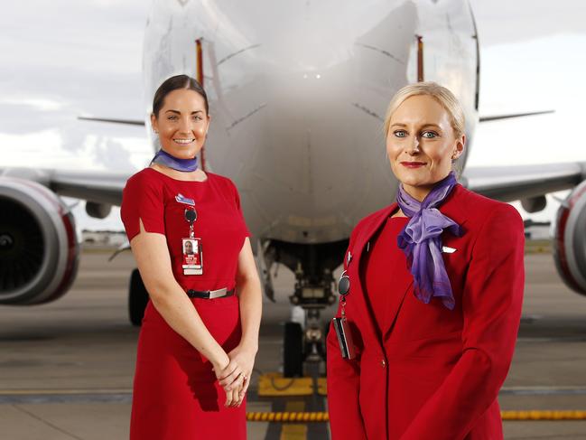 Virgin staff Alahna Wilkinson and Alice Whittle posing in front of Long Beach, 737-800 at the Brisbane Domestic Airport, Brisbane 14th of May 2020.