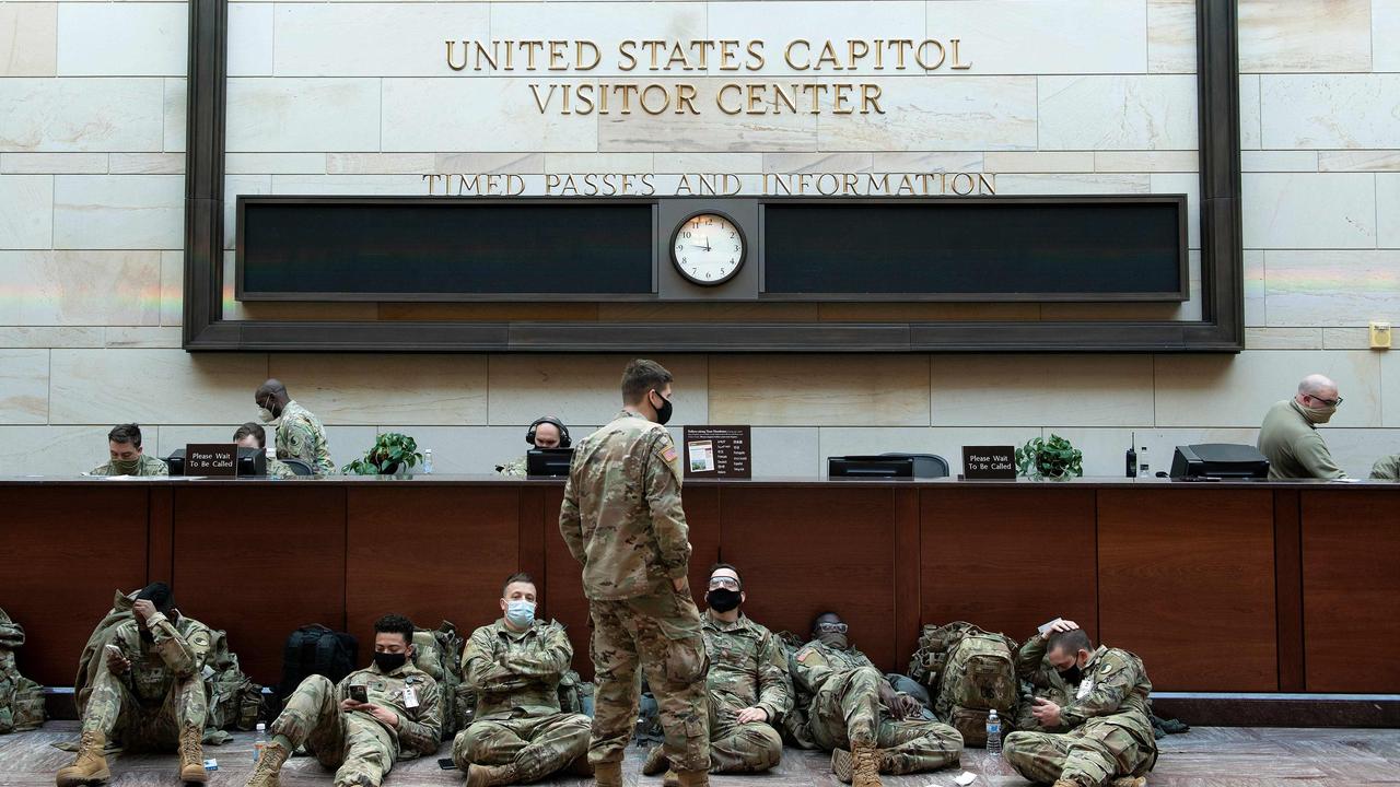 National Guard members rest ahead of the debate today. Picture: Brendan Smialowski / AFP