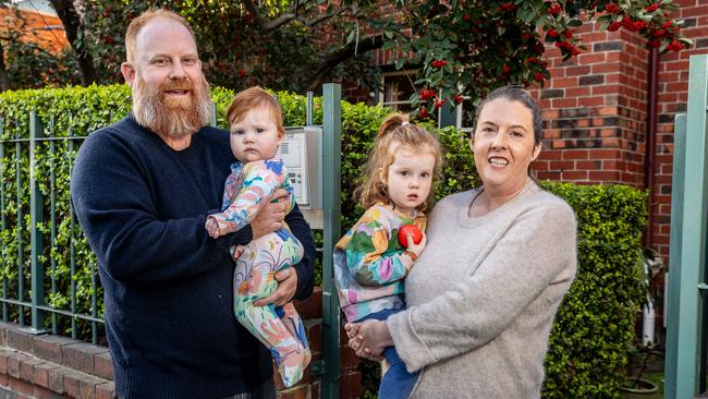 St Kilda family Joanne Hansen, Damien Taylor and their two daughters Maggie and Lucy are upsizing from their two-bedroom apartment. Picture: Jake Nowakowski.