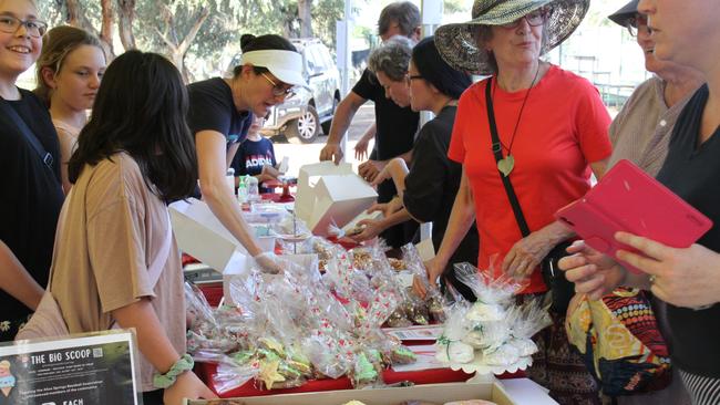 Dozens have descended on the Alice Springs baseball field on Friday, December 13 to attend a bake sale to raise funds for the Siguenza family. Picture: Gera Kazakov