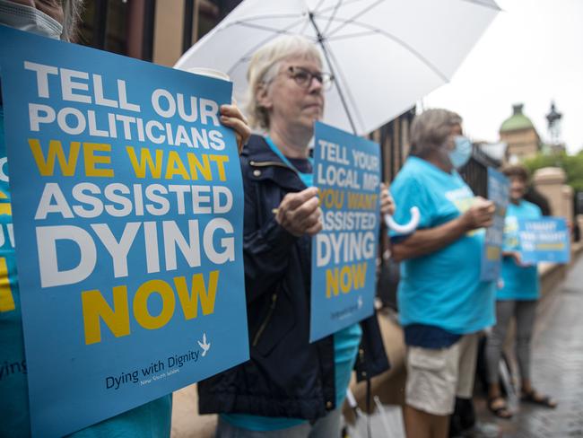 SYDNEY, AUSTRALIA - NewsWire Photos NOVEMBER 25, 2021 - Protesters stand outside the NSW Parliament in Sydney as they agree with the voluntary assisted dying bill.Picture: NCA NewsWire / Christian Gilles