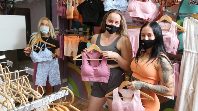 Cassandra Hopper has launched her own active wear label. Kass and Ko owner Cassandra Hopper helps customers Kate Polley and Alice Murphy pick out some new gym gear to wear. Picture: Brendan Radke