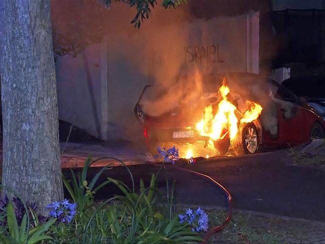 Cars have been set alight near anti-Semitic vandalism in Sydney’s eastern suburbs. , Emergency services responded to reports of a car fire on Magney Street in Woollahra about 1am on Wednesday., Fire & Rescue NSW managed to extinguish the fire, however the car was vandalised along with two buildings, the footpath along Magney Street, and another car. Picture: Supplied