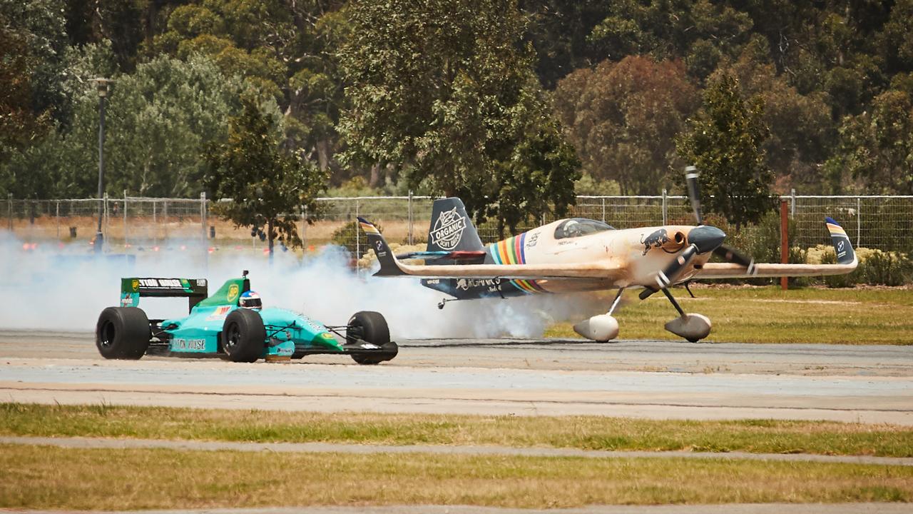 Matt Hall in the MXS-R Red Bull Air Race plane took on three cars at the Adelaide Motorsport Festival on Sunday. Picture: Matt Loxton