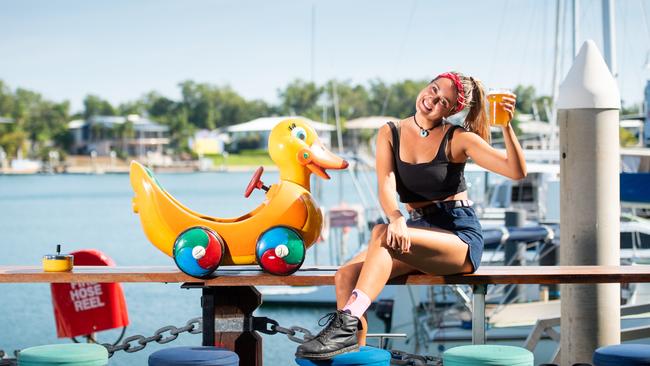 Bree Richards from Lola's Pergola, Darwin, stops for a refresher after her shift, as the bar reopened for the first time in 53 days the COVID-19 shutdown last year. Picture: Che Chorley