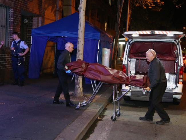 The man’s body is taken away after the fatal fall. Picture: Adam Taylor