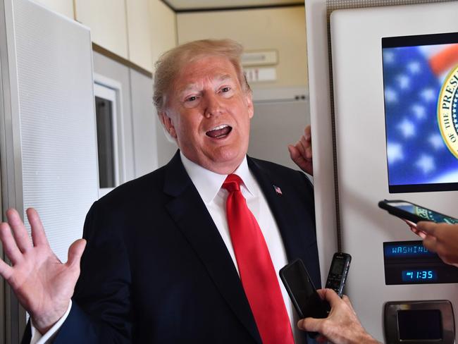 US President Donald Trump speaks to the press aboard Air Force One on September 7, 2018, as he travels to Fargo, North Dakota, to speak at a Joint Fundraising Committee. (Photo by Nicholas Kamm / AFP)
