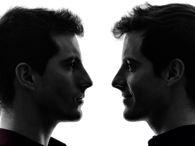 close up portrait two caucasian young men in shadow white background