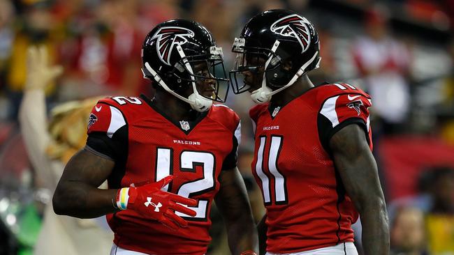 Mohamed Sanu #12 of the Atlanta Falcons reacts with Julio Jones #11 after pulling in the game-tying touchdown against the Green Bay Packers.