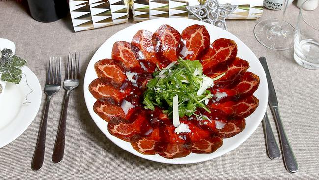 Bresaola Dry Cured Eye Fillet thinly sliced served with Truffle Pecorino Cheese topped with a Rocket olive Oil Vinegar Salad Photo: David Clark