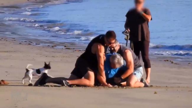 Career fraudster Peter Foster is crash tackled and arrested on Four Mile Beach at Port Douglas. Picture: Channel 9