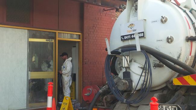 A worker out the back of the China Chilli restaurant in Gouger St after up to 68,000 litres of wa A worker out the back of the China Chilli restaurant in Gouger St after up to 68,000 litres of waste water was discovered in its basement. Picture: Andrew Hough