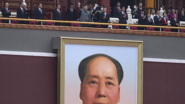 Xi, top centre above a portrait of Chairman Mao, addresses the crowd at a ceremony in Tiananmen Square. Picture: Kevin Frayer/Getty Images/The Times