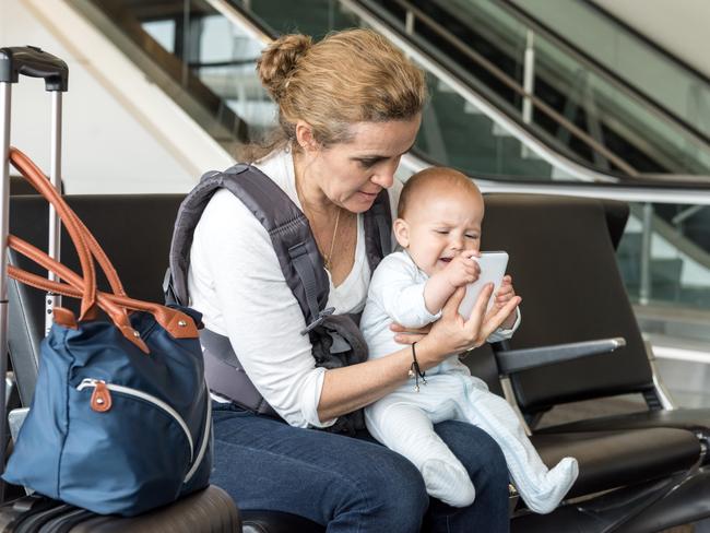 Flying with babies involves careful planning. A phone is also handy. Picture: IStock