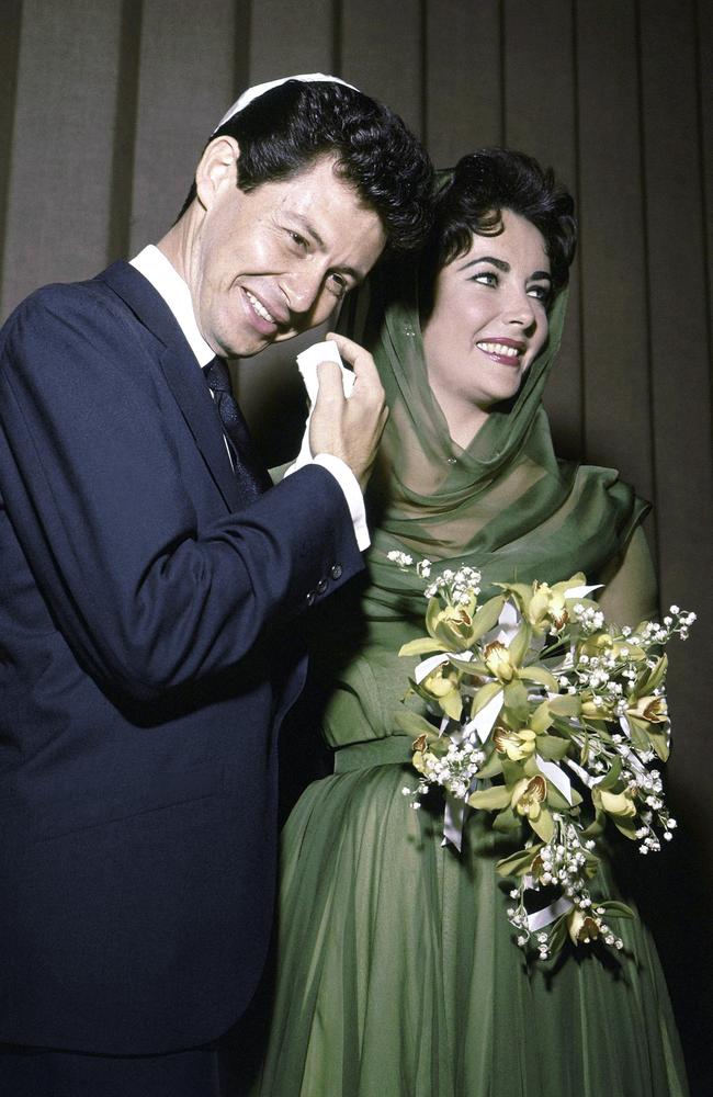 Eddie Fisher and actor bride Elizabeth Taylor posing for the media after their marriage in Las Vegas in 1959.