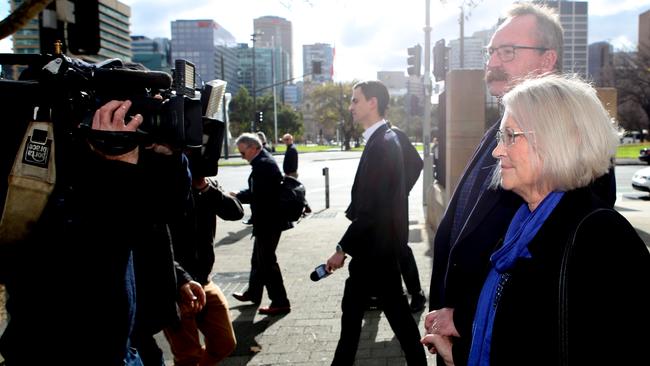 Ex-Labor MP Annabel Digance and her husband Greg Digance face TV cameras as they leave Adelaide Magistrates Court on blackmail charges. Picture: NCA NewsWire / Kelly Barnes