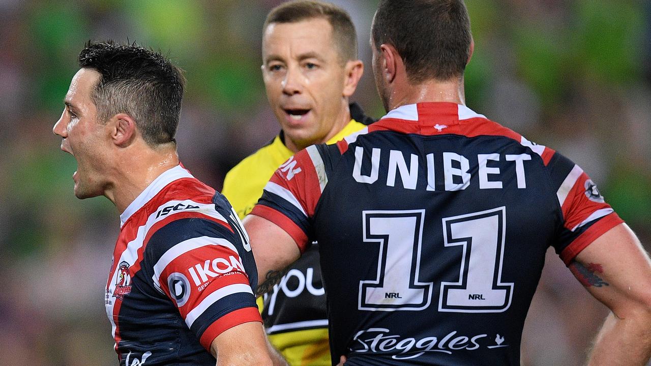 Cooper Cronk of the Roosters and referee Ben Cummins.