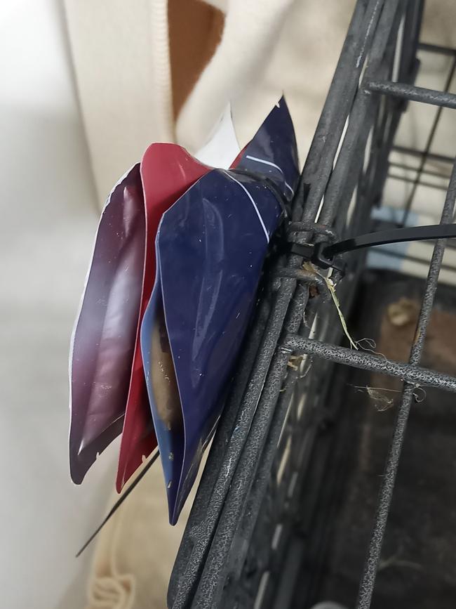 Packets of food zip tied to the dumped cat’s cage. Pictures: Supplied/RSPCA