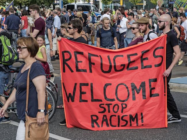 Protesters demonstrate with a banner 'Refugees welcome!' in Dresden, Germany / Picture: AP