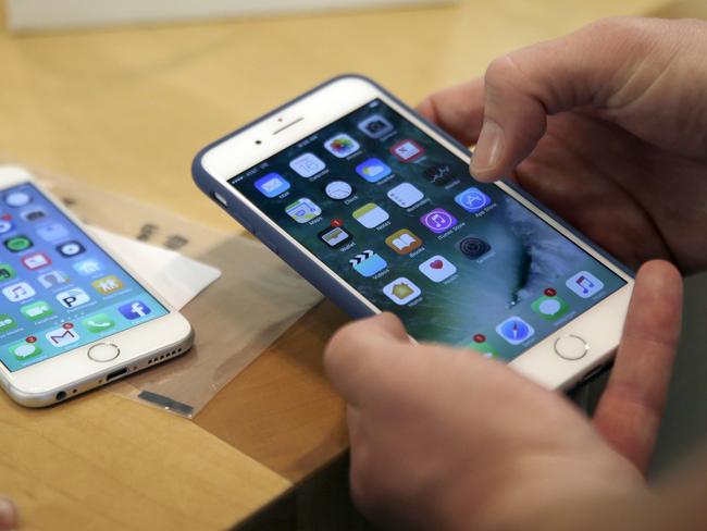 FILE - In this Friday, Sept. 16, 2016, file photo, a customer sets up his new iPhone 7 Plus, right, as he switches from the iPhone 6 at the Apple Store on Michigan Avenue during the release of the Apple iPhone 7 and the latest Apple Watches, in Chicago. New documents from WikiLeaks, posted Thursday, March 23, 2017, point to an apparent CIA program to hack Appleâ€™s iPhones and Mac computers such that the exploits persist even after the devices are reset to factory conditions. Apple says the purported hacking techniques have all been fixed in recent iPhones and Mac computers. (AP Photo/Kiichiro Sato, File)