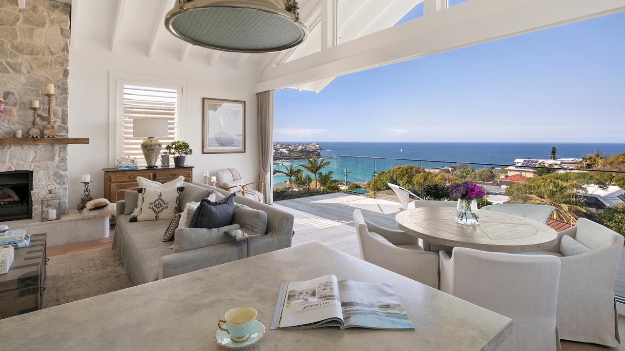 The huge living room opens to a terrace with views up and down the coastline.
