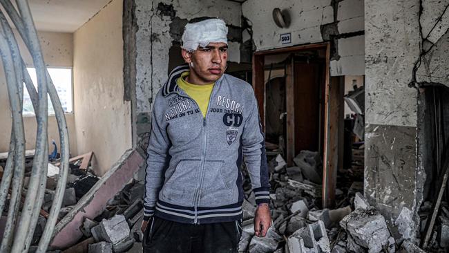 An injured young man inspects the rubble and debris of a building that was hit by overnight Israeli bombardment in Rafah in the southern Gaza Strip. Picture: AFP