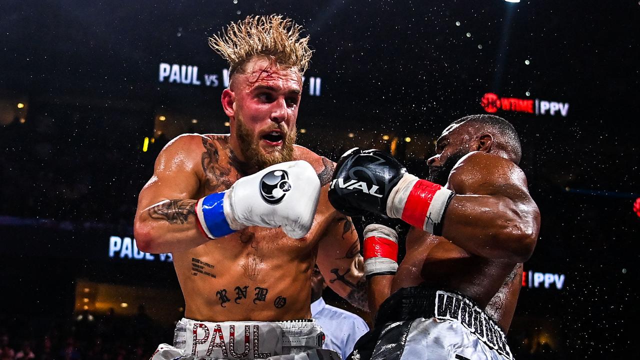 LYouTube personality Jake Paul (L) and former UFC welterweight champion Tyron Woodley fight at the Amalie Arena in Tampa, Florida, on December 18, 2021. (Photo by CHANDAN KHANNA / AFP)