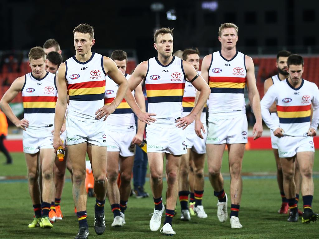 CANBERRA, AUSTRALIAN CAPITAL TERRITORY - AUGUST 11:  Crows players look dejected as they walk from the pitch during the round 21 AFL match between the Greater Western Sydney Giants and the Adelaide Crows at UNSW Canberra Oval on August 11, 2018 in Canberra, Australia.  (Photo by Matt King/AFL Media/Getty Images)