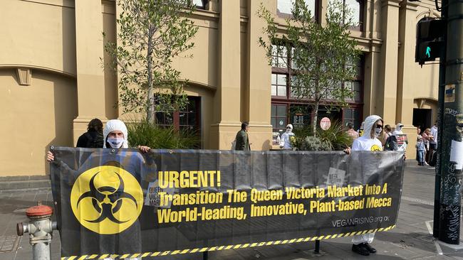 Wearing white biohazard suits, the group held large banners.