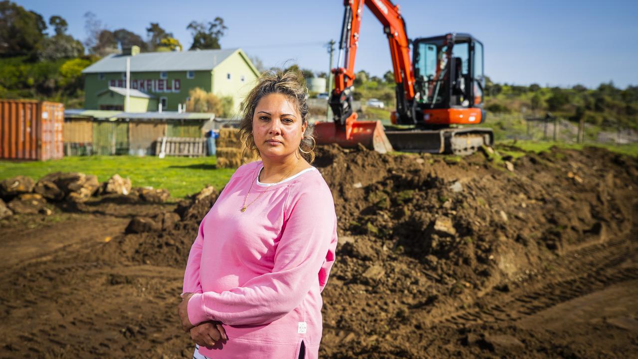 Brookfield business owner Julia Ridgers with the partially demolished levee leaving the property once again at risk of flooding. The Brookfield property was devastated by floods in 2018 and the landlord built a levee to fix the issue, but DPIPWE has asked them to remove it within three months or risk a fine. Picture: Richard Jupe