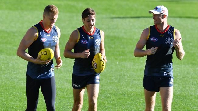 (L-R) Reilly O'Brien, Jake Kelly and Alex Keath of the Crows are seen during a training session at Adelaide Oval, Adelaide, Tuesday, April 2, 2019. (AAP Image/David Mariuz) NO ARCHIVING