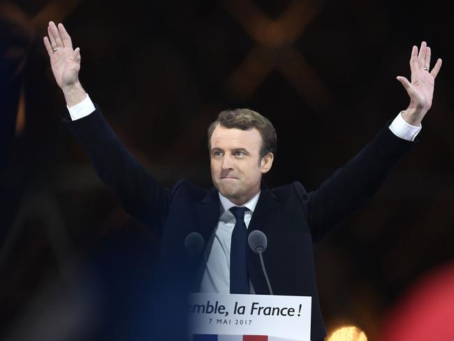 French president-elect Emmanuel Macron greets supporters before delivering a speech in front of the Pyramid at the Louvre Museum in Paris on May 7, 2017, after the second round of the French presidential election. Emmanuel Macron was elected French president on May 7, 2017 in a resounding victory over far-right Front National (FN - National Front) rival after a deeply divisive campaign, initial estimates showed. / AFP PHOTO / Eric FEFERBERG