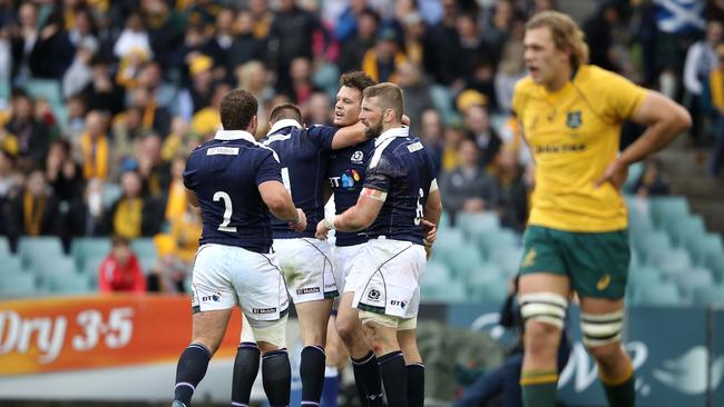 Duncan Taylor of Scotland celebrates with his team mates after scoring a try.