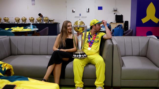 AHMEDABAD, INDIA - NOVEMBER 19: Travis Head of Australia poses with the ICC Men's Cricket World Cup Trophy alongside his wife Jessica following the ICC Men's Cricket World Cup India 2023 Final between India and Australia at Narendra Modi Stadium on November 19, 2023 in Ahmedabad, India. (Photo by Robert Cianflone/Getty Images)