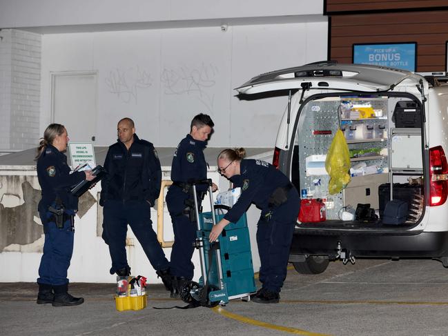 Police pictured preparing to enter an apartment building on the corner of Canterbury Road and Canton Street in Canterbury where bodies of two women were found deceased. Picture: Damian Shaw