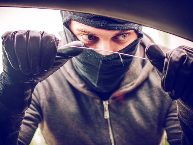 Car thief looking through the open window