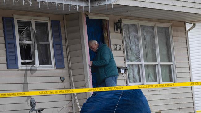 Workers repair the home of 15-year-old Natalie Rupnow after it was damaged as police made entry. Picture: Getty Images via AFP.