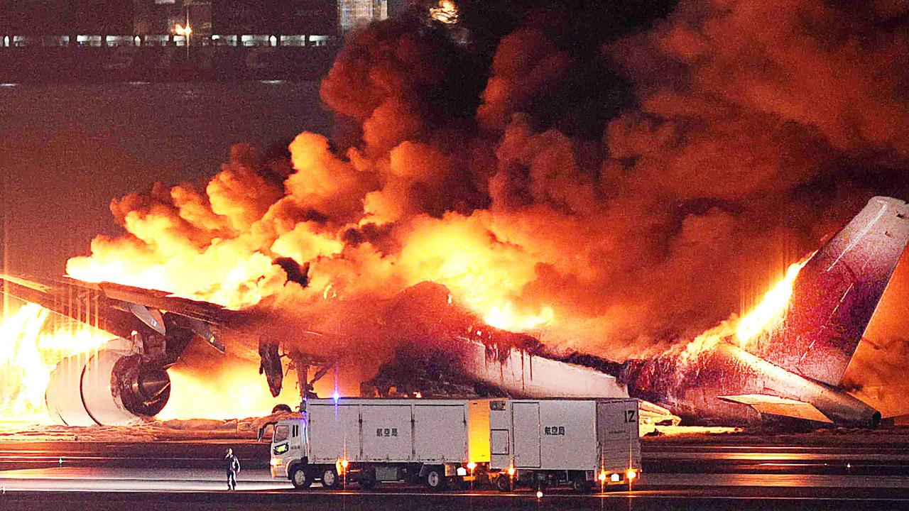 A Japan Airlines plane was engulfed in flames on the runway of Tokyo’s Haneda Airport after apparently colliding with a coast guard aircraft. Picture: AFP