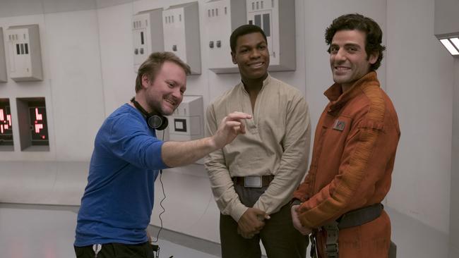 Director Rian Johnson with actors John Boyega and Oscar Isaac.