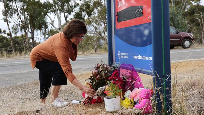 A woman leaves flowers for Kobi at the growing memorial site. Picture: NCA NewsWire / David Mariuz