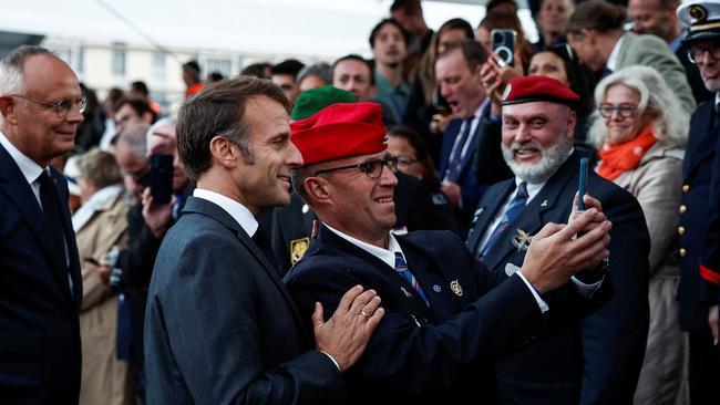 French President Emmanuel Macron poses for a selfie this week with a man during a ceremony commemorating the WWII liberation of the port city of Le Havre. Picture: Benoit Tessier / POOL / AFP