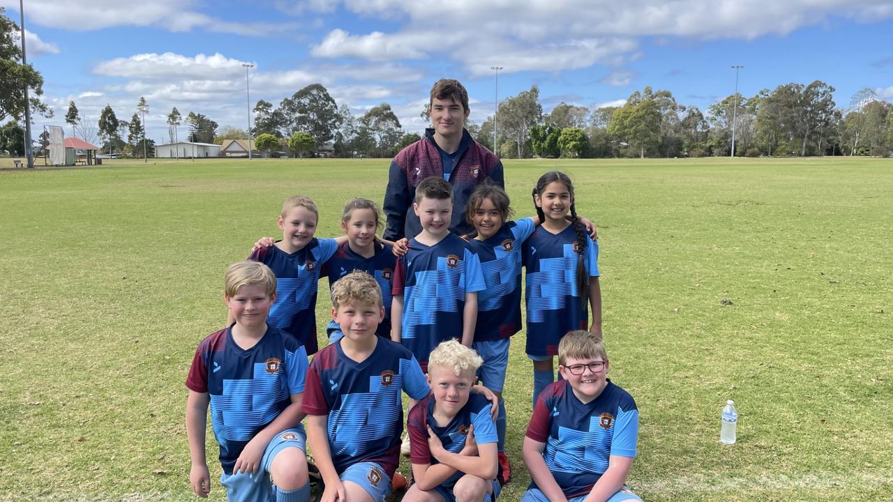 St Albans under-8 team members (back from left) coach Lachie, Theo, William, Memphis, Liam, Tommy, Riley, Connor, Jojo and Sahib celebrate their Team of the Week win.